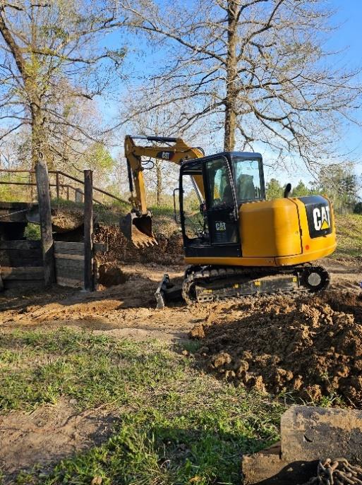 Compact excavator working on a small excavation project
